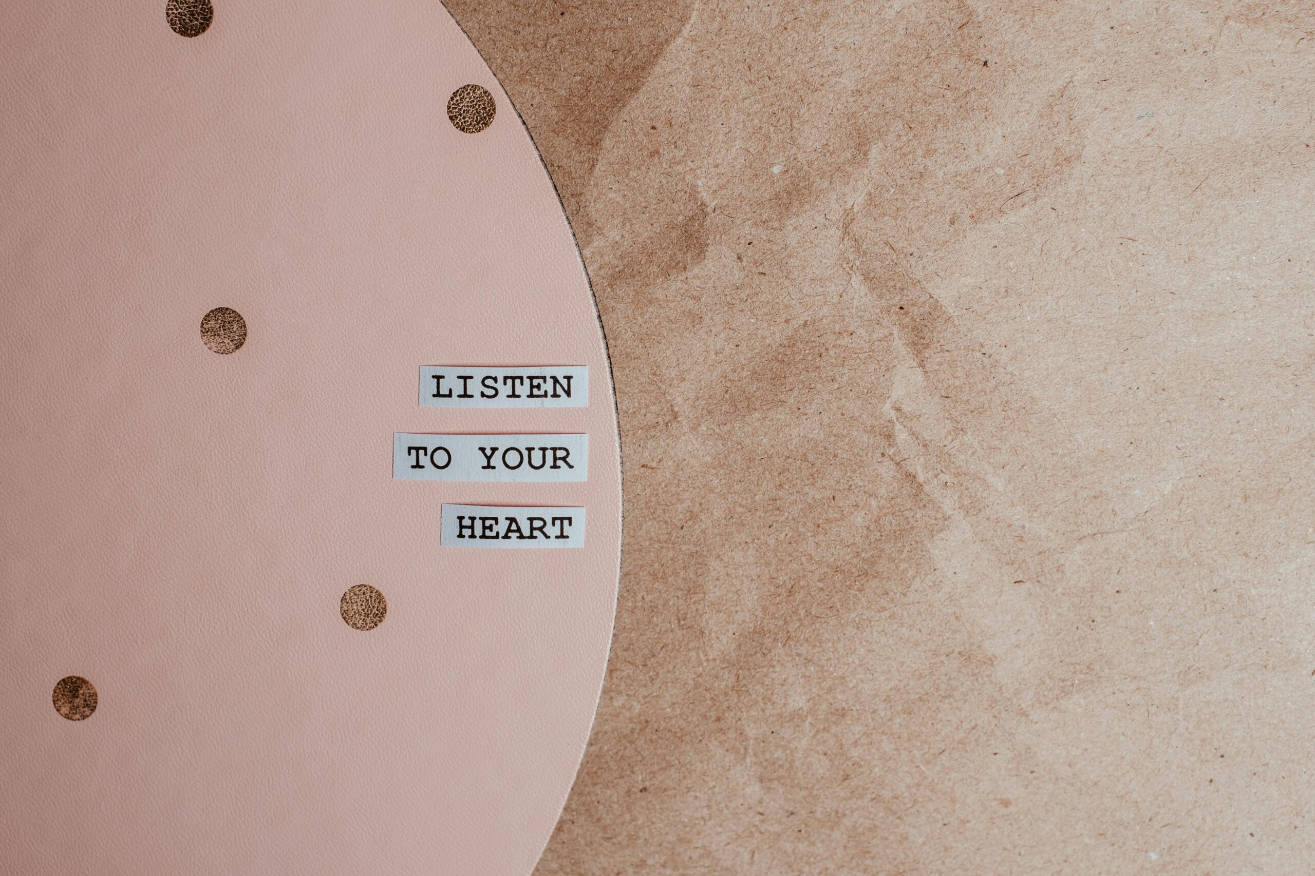 Motivational quote 'Listen to your heart' on a stylish pink and brown textured background.